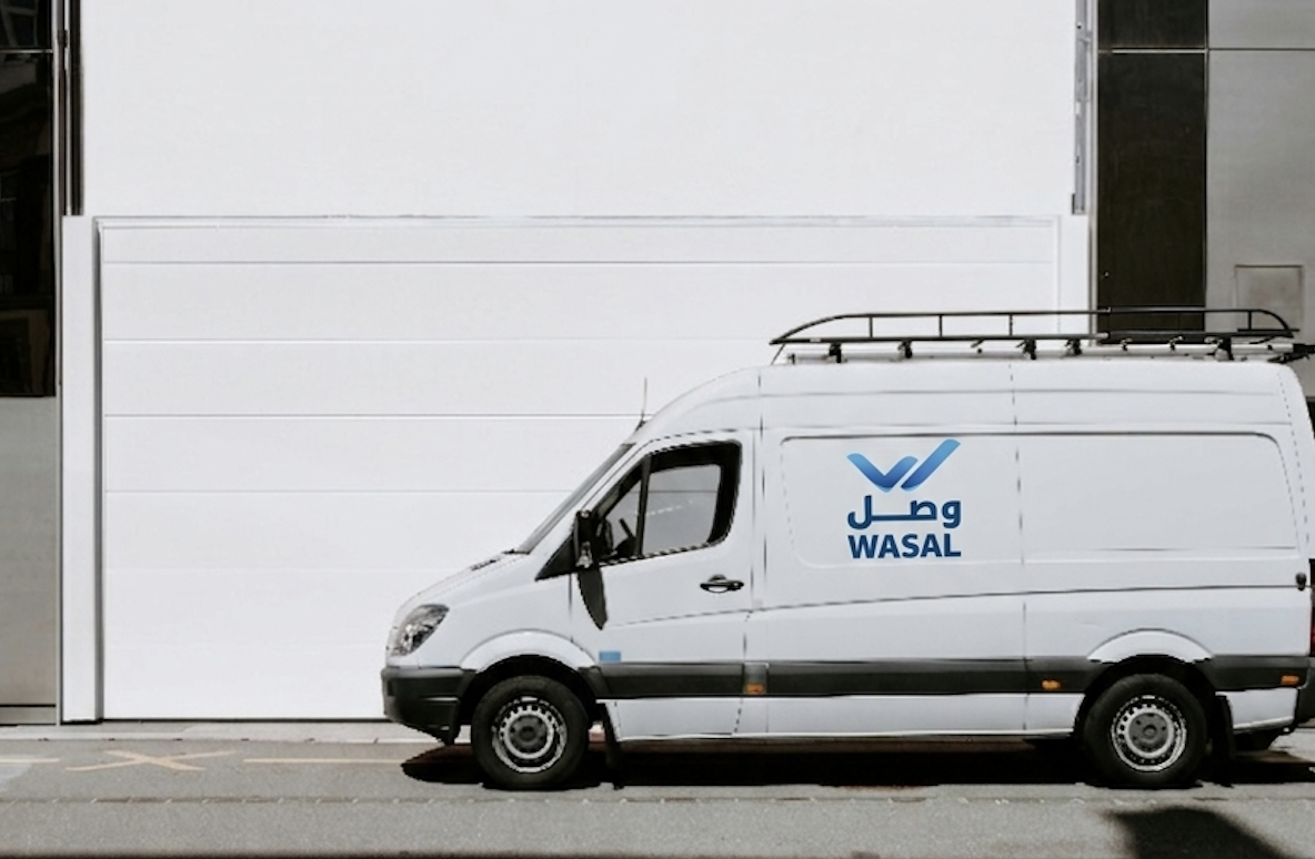 Delivery rider moving through Kuwait city streets